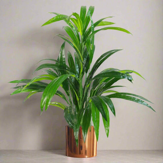 Artificial 65cm bamboo shrub with glossy green leaves in a copper metal planter, displayed against a neutral wall.