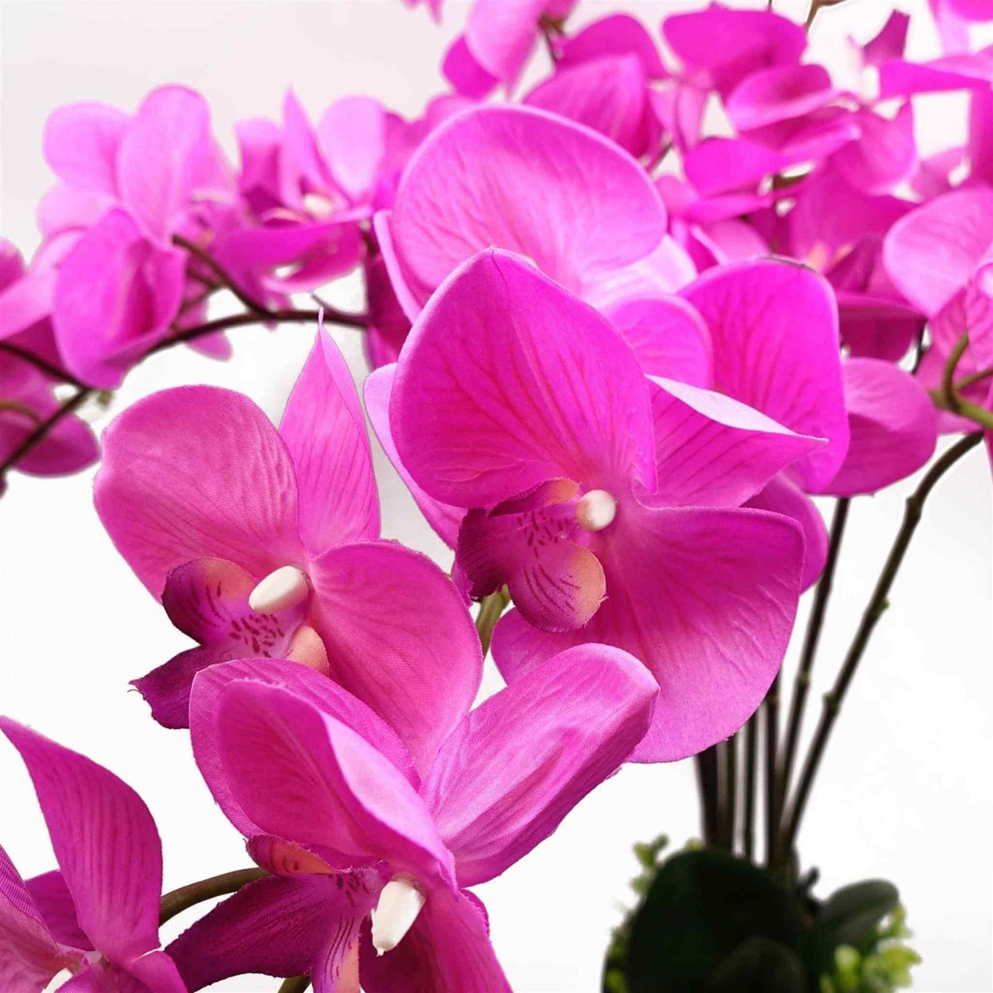 Close-up of lifelike dark pink orchid petals showing natural texture and detail.
