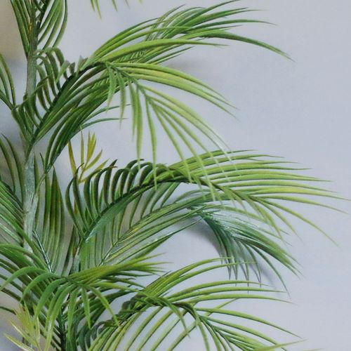 Detailed view of the wired plastic palm leaves on the 90cm artificial palm tree, arranged for realistic shape.