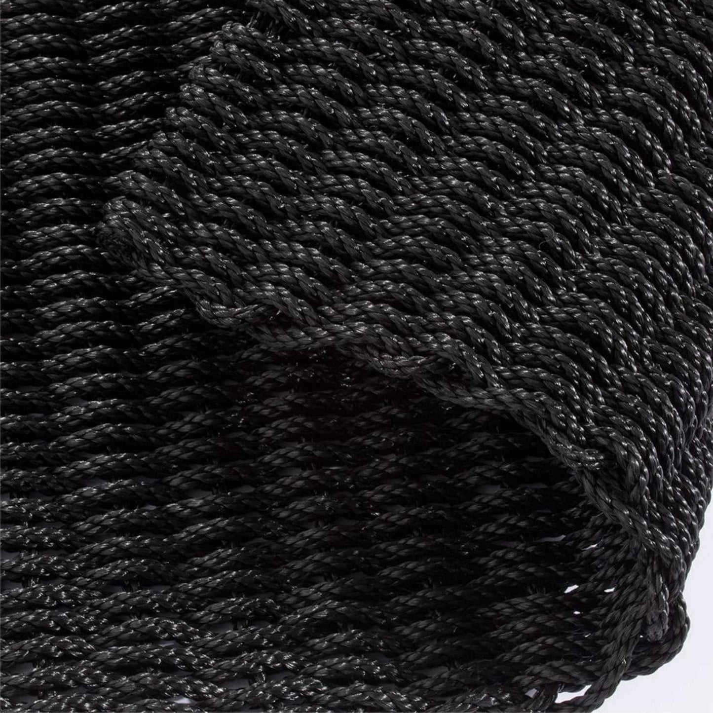Close-up of navy braided polypropylene doormat showing twisted rope texture.