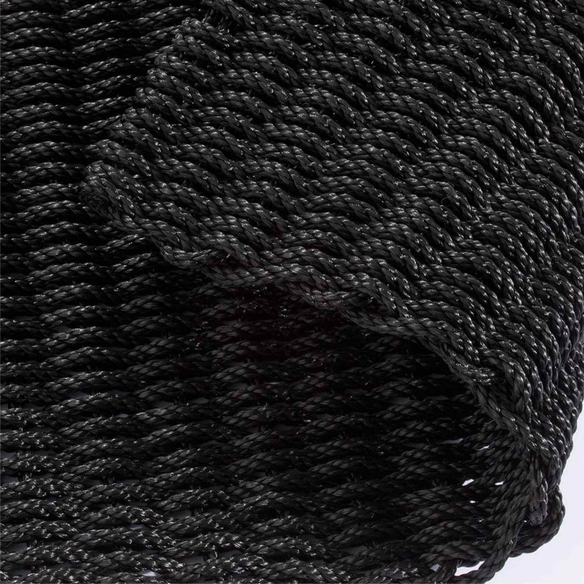 Close-up of navy braided polypropylene doormat showing twisted rope texture.