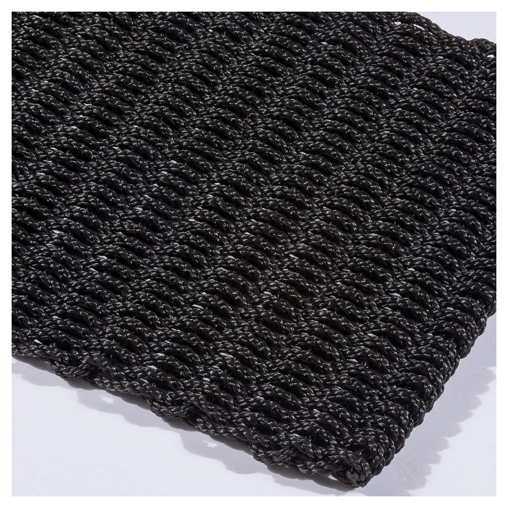 Angled view of polypropylene braided doormat showing thickness and texture.