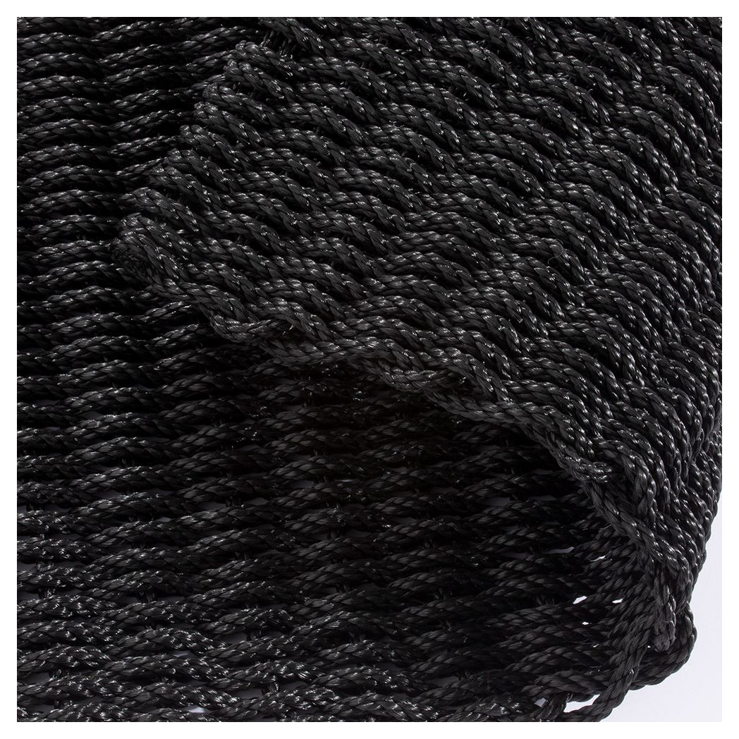 Close-up of black braided polypropylene doormat texture, showing twisted rope detail.