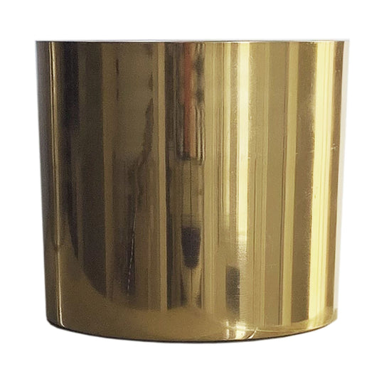Polished gold metal planter, cylindrical shape, empty, set against a plain white background.