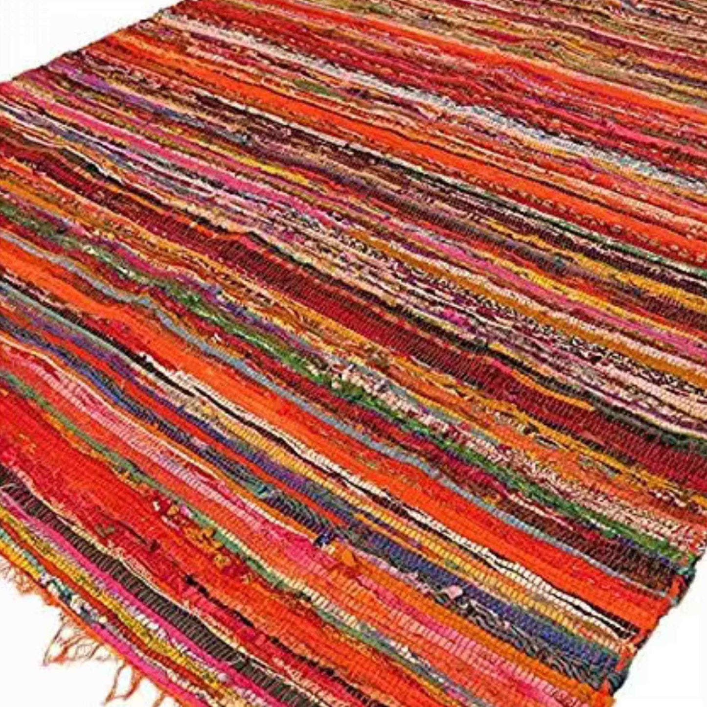 Luxury Indian rag rug 150x90cm with orange fringe and colourful striped weave, laid flat on the floor.