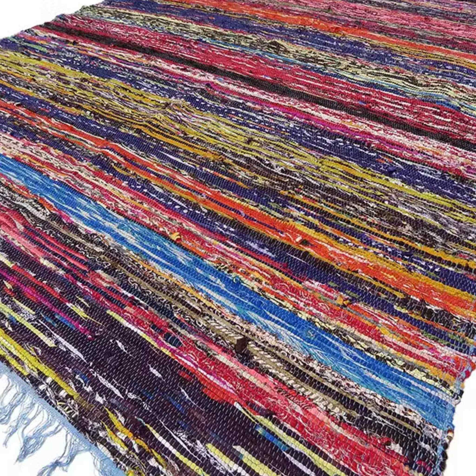 Full-length view of a multicoloured Indian rag rug with horizontal stripes in red, blue, and yellow shades.