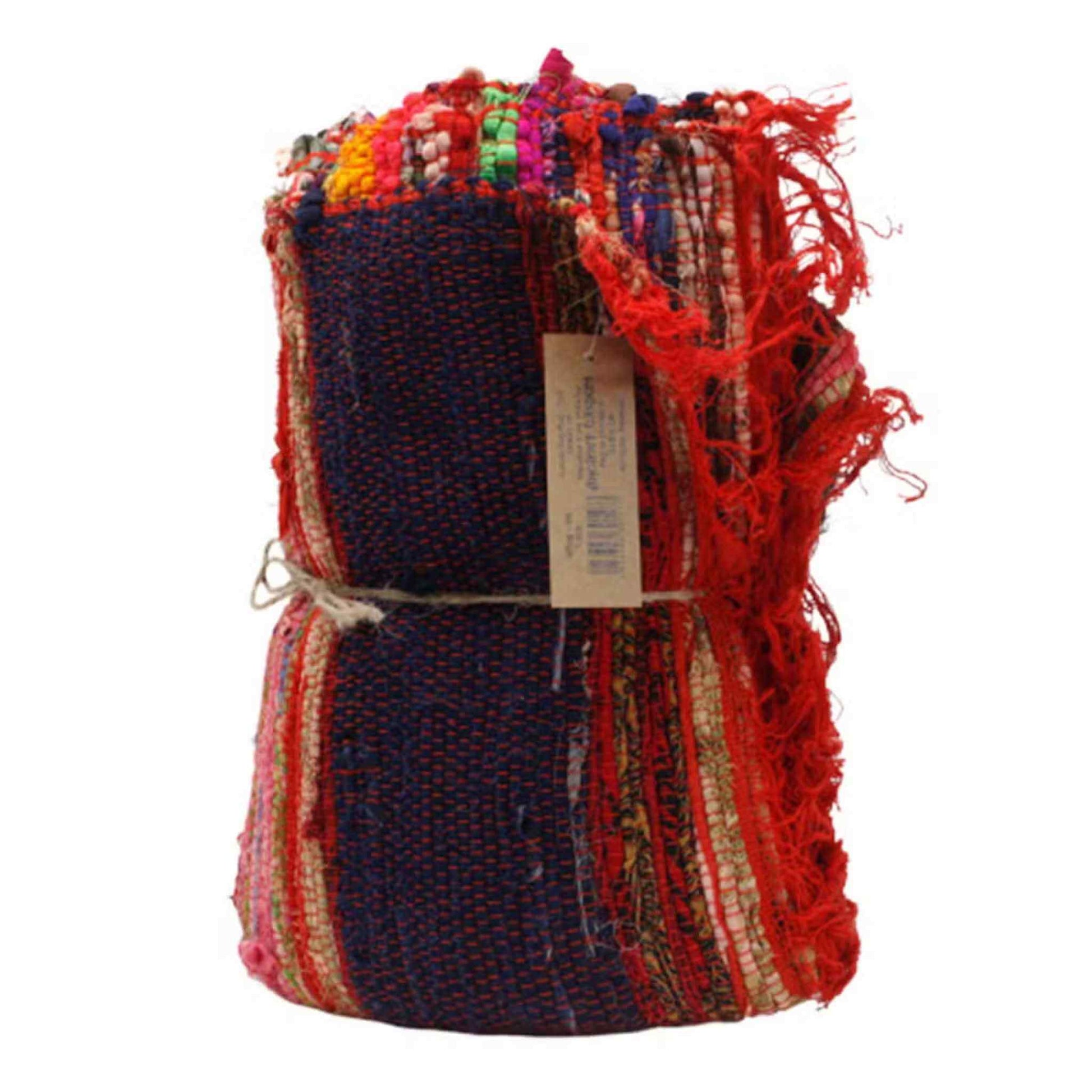 Folded and tied red cotton rag rug standing upright showing layered texture and multicoloured woven pattern.