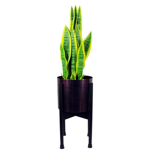 A tall green plant placed inside the iridescent metal pot, styled with a black stand.