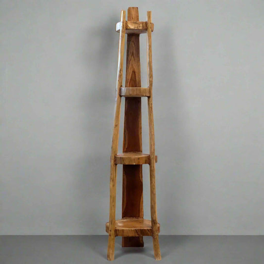 Natural teak 135cm corner unit with four fixed shelves, showing smooth wood grain and tapered shape against a grey wall.