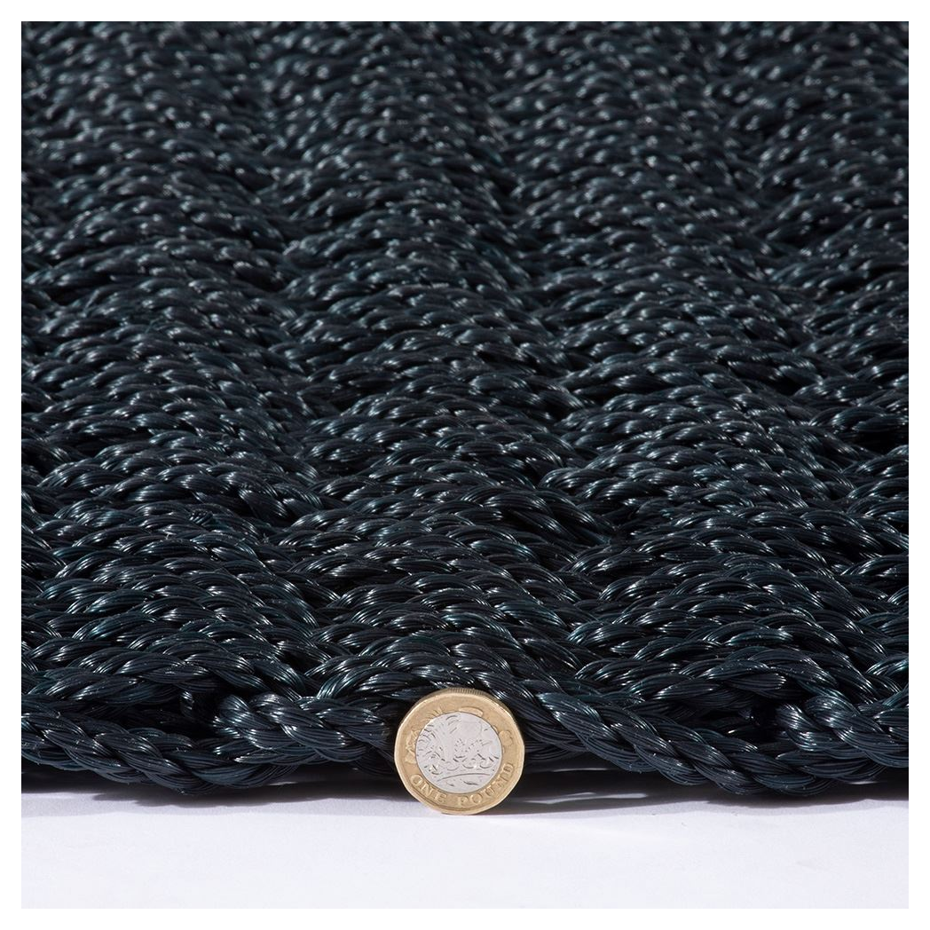 Navy braided doormat with pound coin for scale, 45x75cm size.