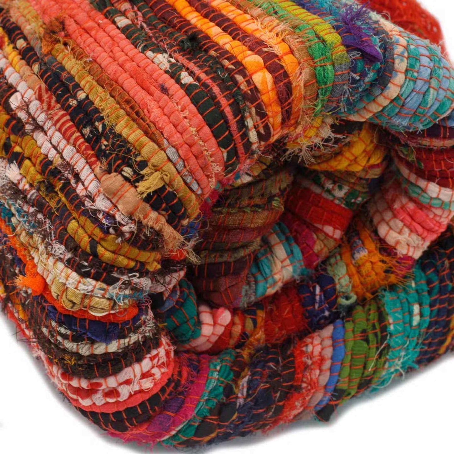 Close‑up of woven recycled cotton in orange Indian rag rug showing mixed fabric texture.