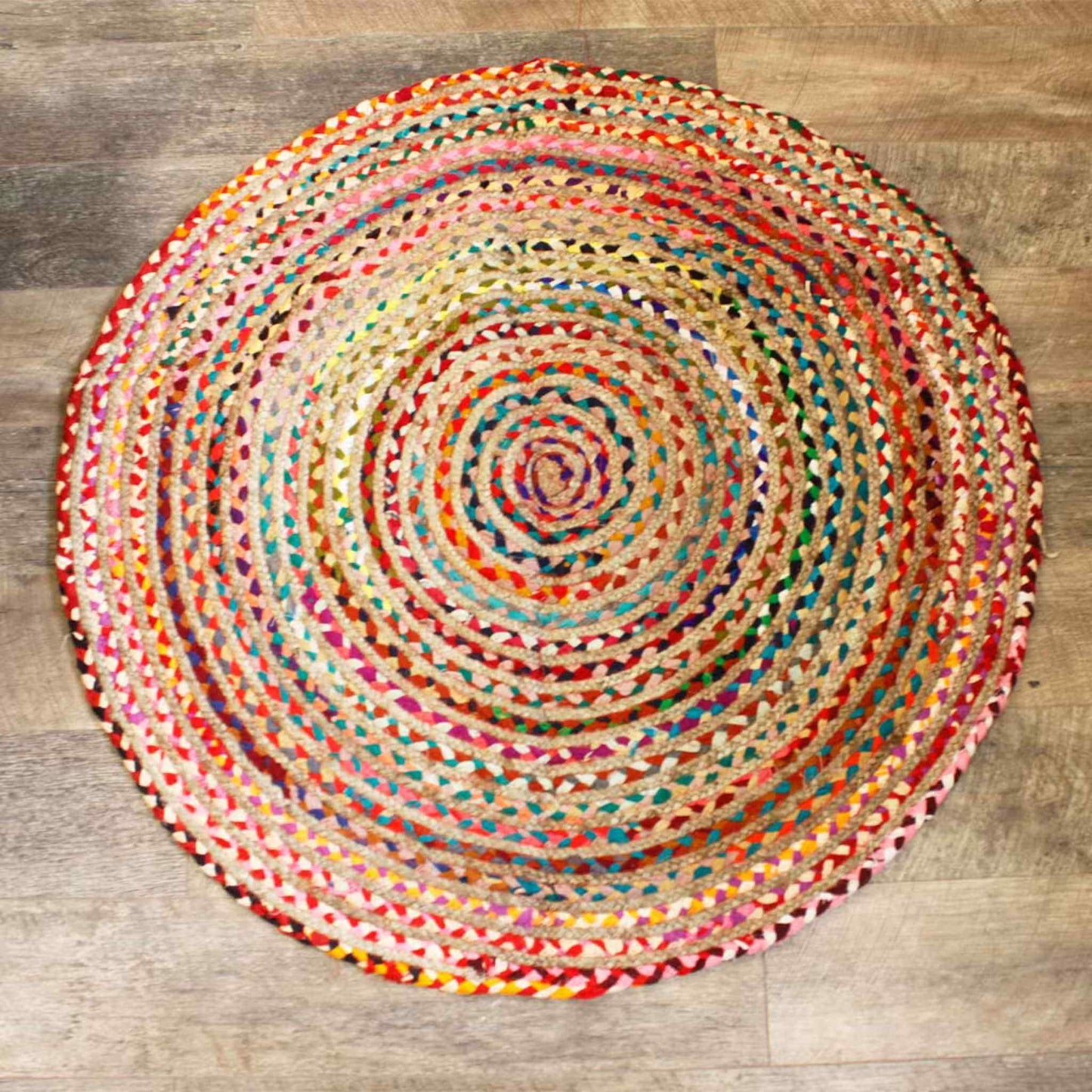 120cm round jute and recycled cotton rug laid flat on a wooden floor.