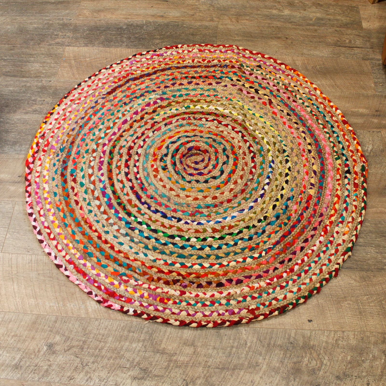Rug displayed in natural light on timber flooring, highlighting rustic, handcrafted texture.