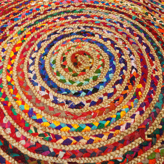 A close-up of the handwoven jute and recycled cotton rug showing vibrant spiral detail and texture.