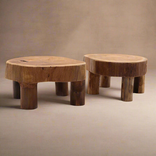 Pair of rustic teak display risers with rounded tops and cylindrical legs, shown at a slight angle.