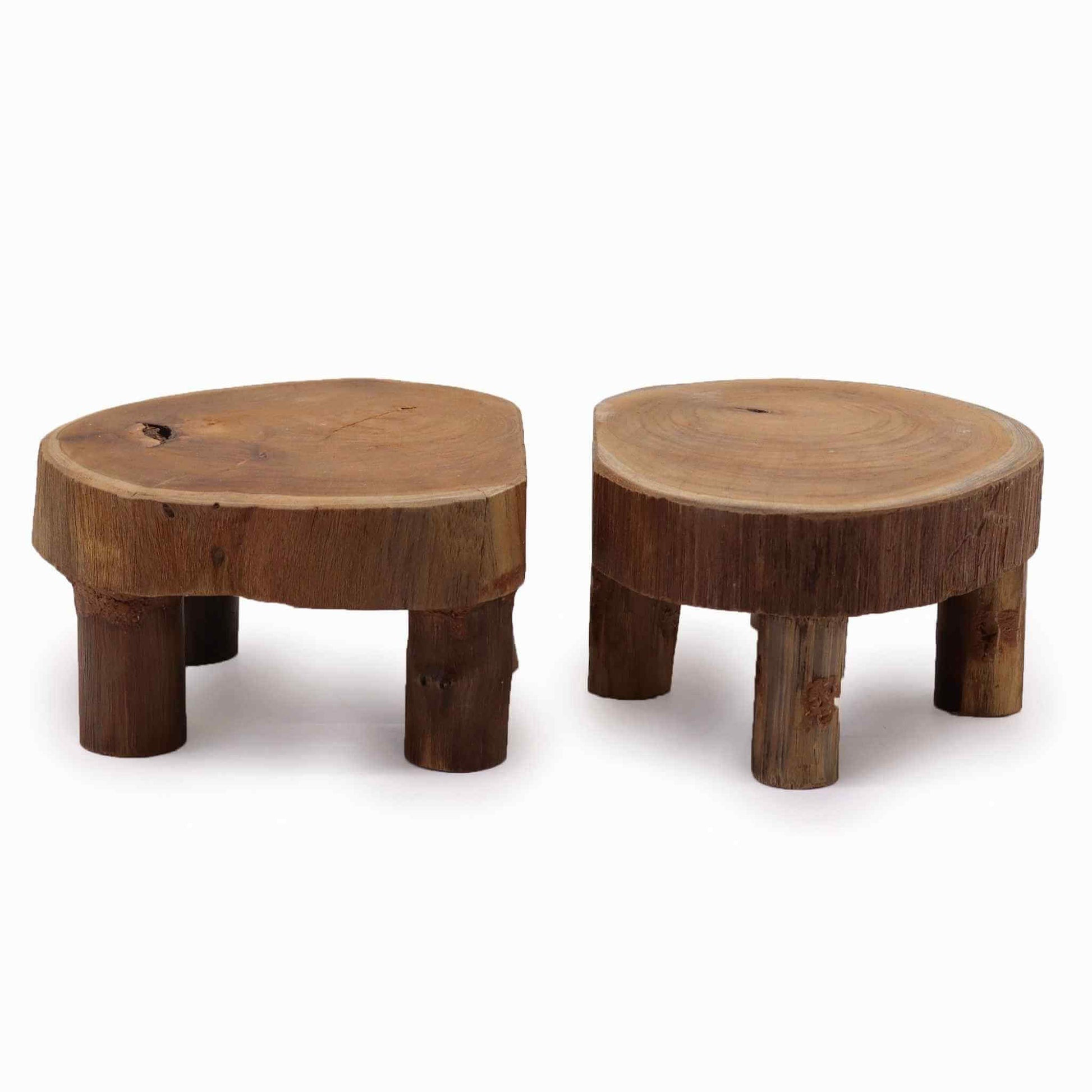 Low teak platforms with rounded tops and sturdy legs, captured against a white background for product detailing.