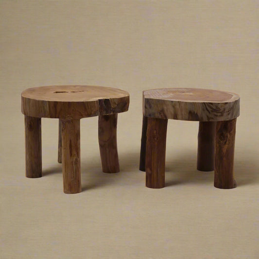 Set of two teak display stands with flat tops and three legs, natural mid-brown wood, 20 cm height.