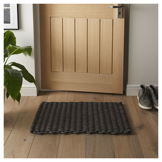 Dark slate braided polypropylene doormat 45x75cm placed by a wooden front door.