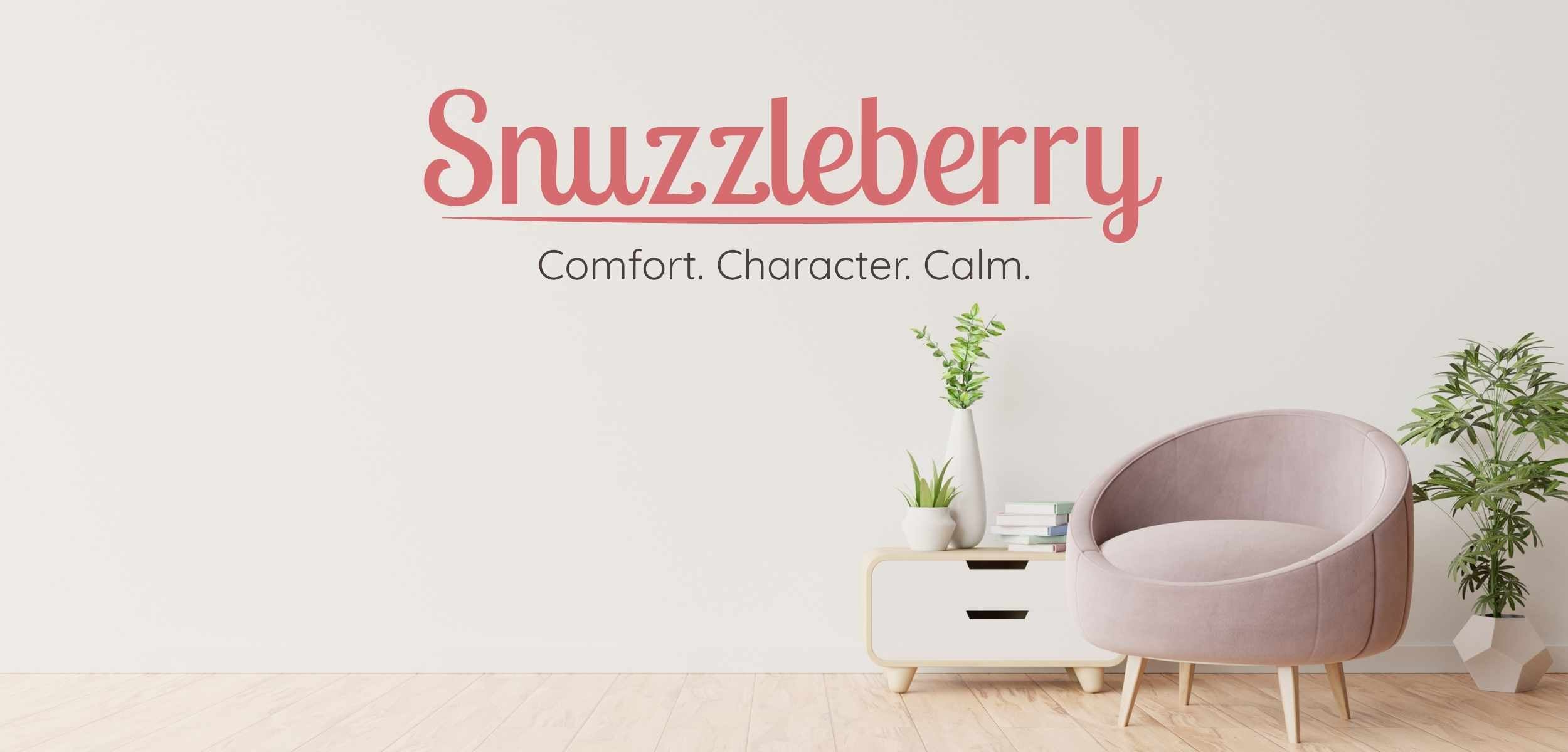 Snuzzleberry hero image—a pink armchair, green plants, and books beside a modern side table, with the Snuzzleberry logo and tagline “Comfort. Character. Calm.” on the wall.