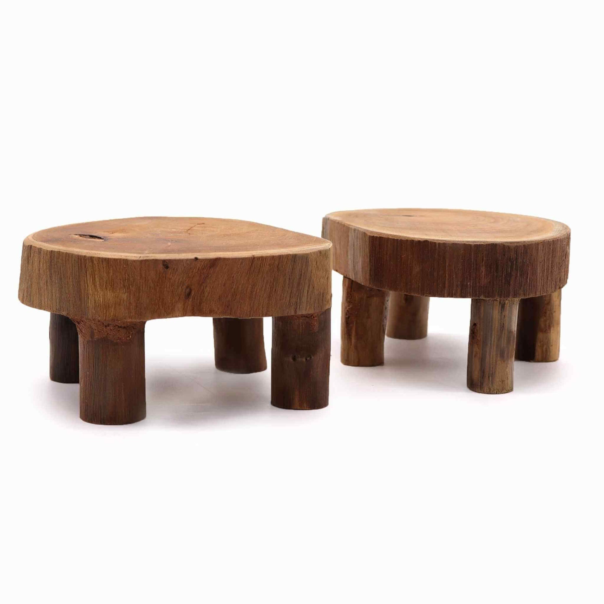 Teak wood display stands, set of two, shown close-up on a white background to show smooth surface texture and rustic edges.