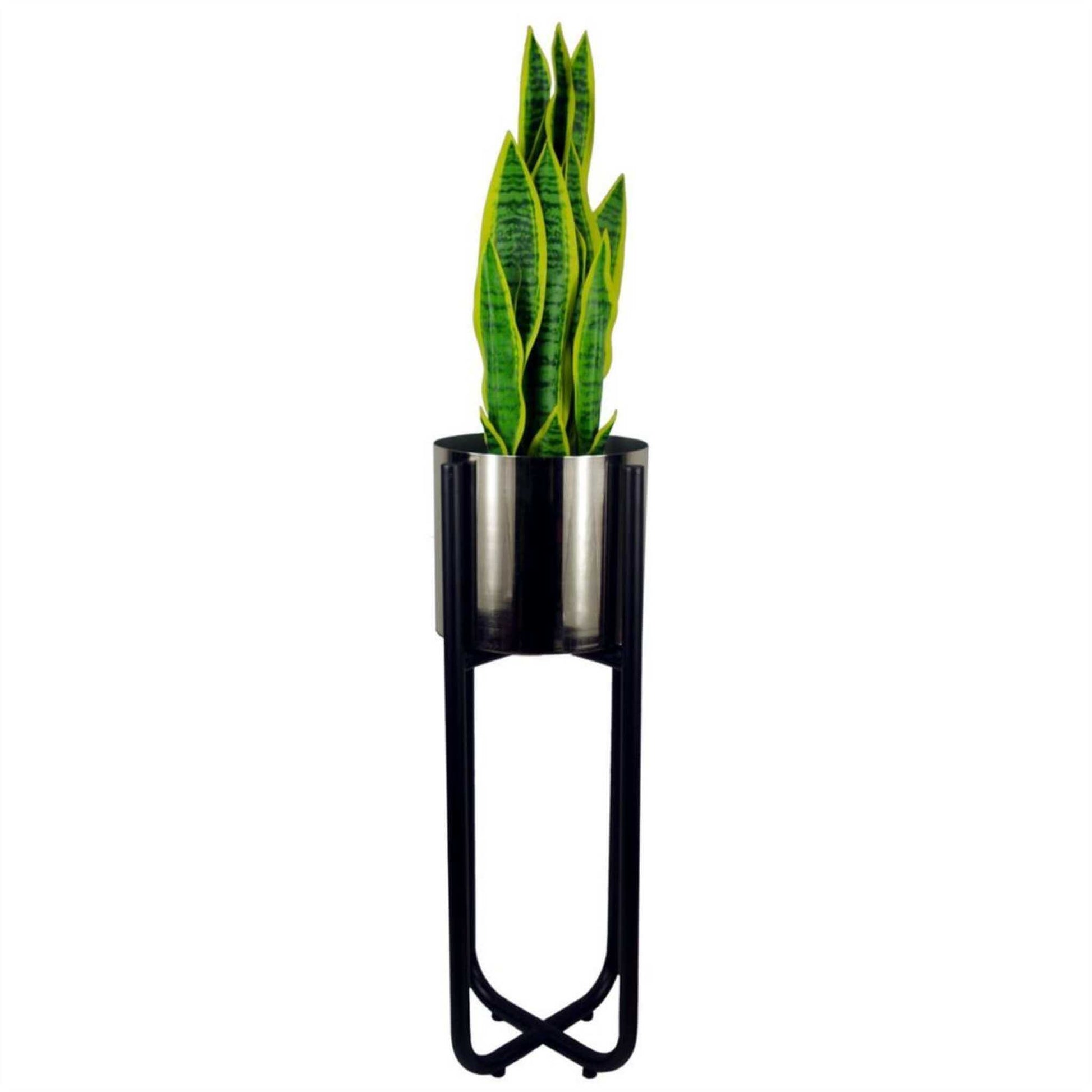 Tall black metal plant stand with silver planter holding a snake plant, shown against a white background. Modern, powder-coated finish, 62cm tall.