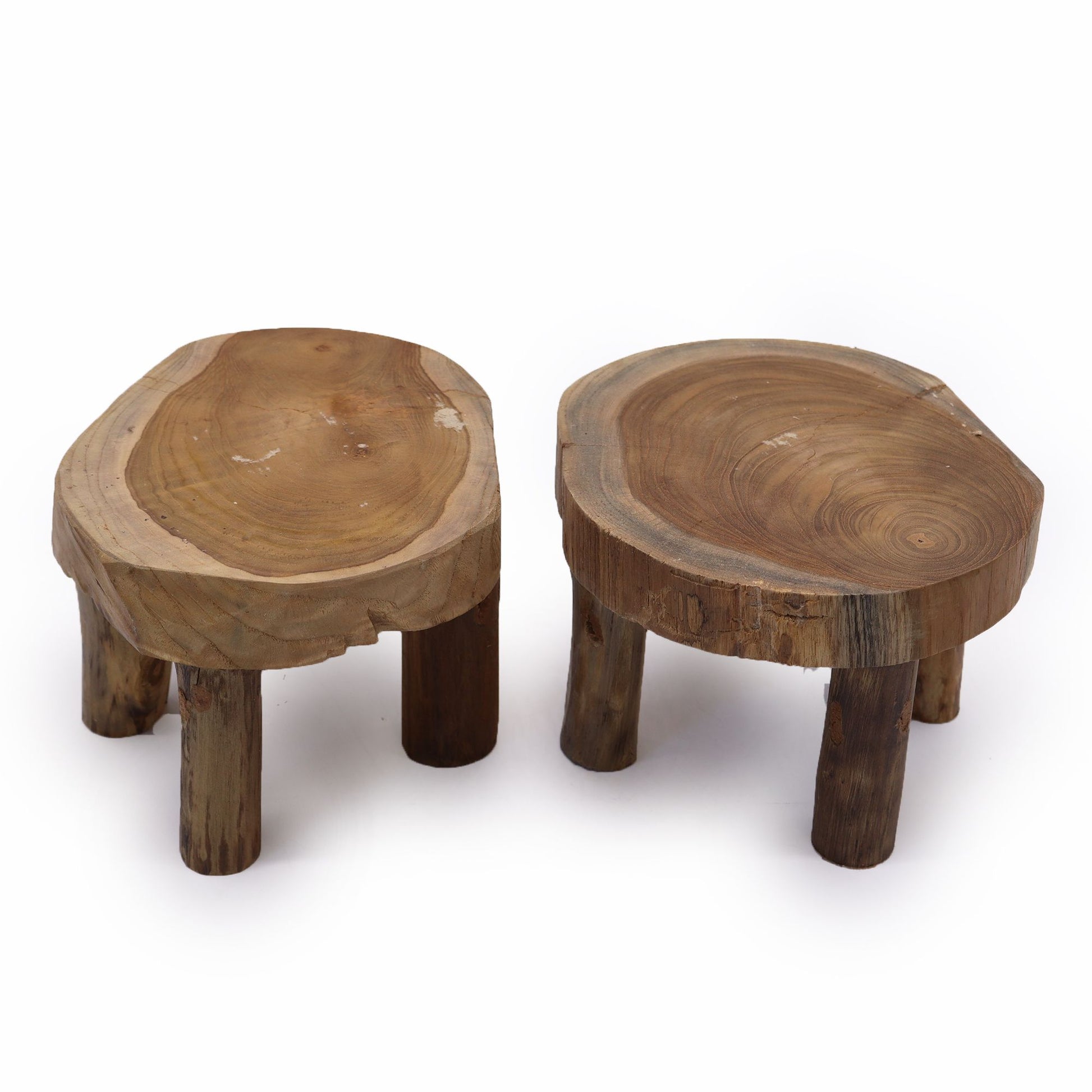 Top-down view of two teak mini stands highlighting natural grain rings and irregular edges on a white backdrop.