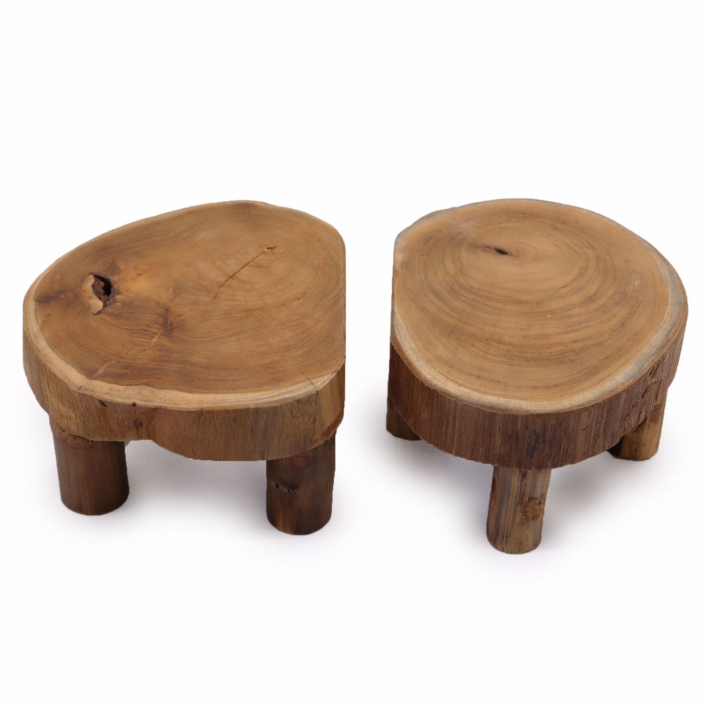 Set of two small round teak wood display stands with natural grain, low three-leg design, on a white background.