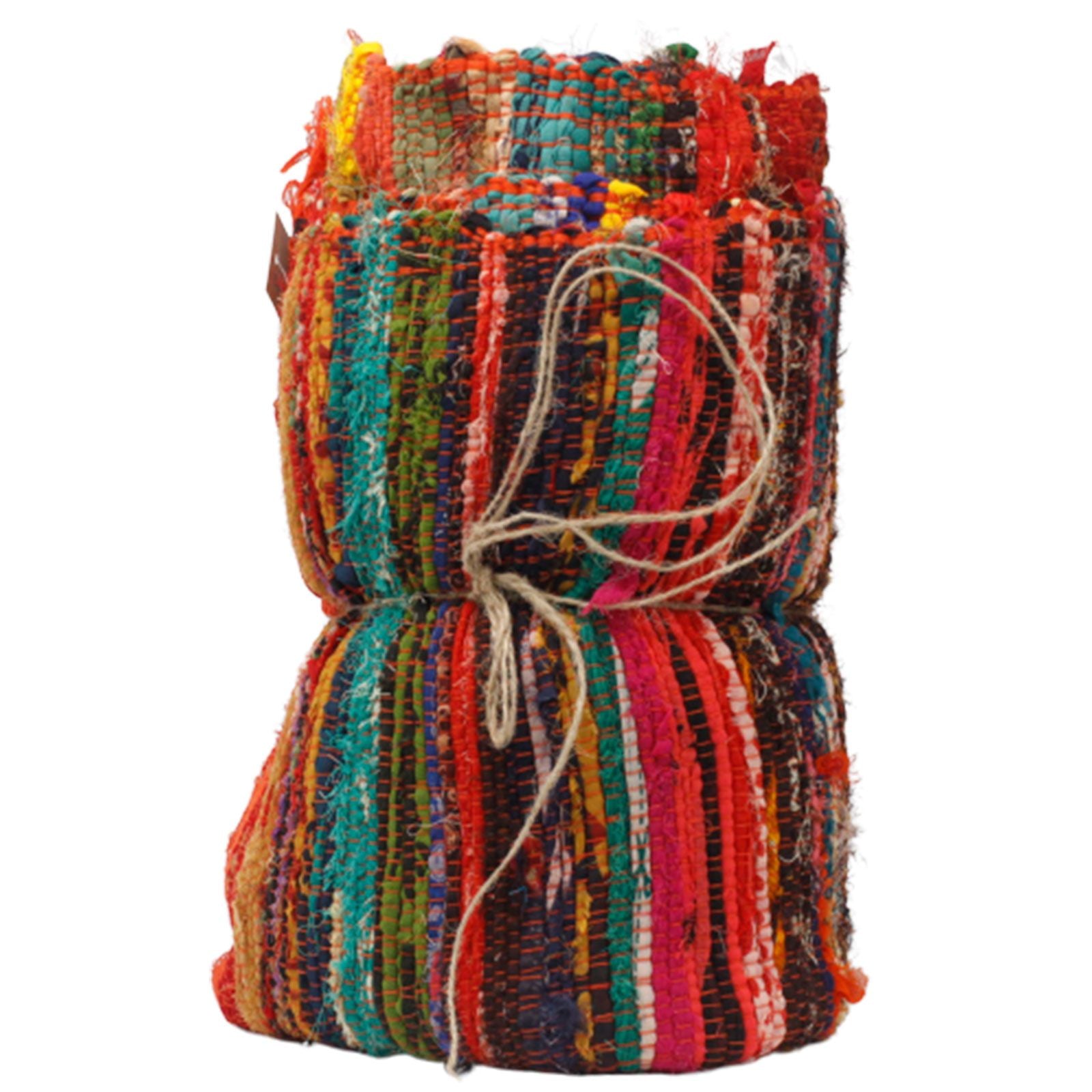 Orange and multicolour rag rug tied with string, standing upright to show rolled pattern and fabric texture.